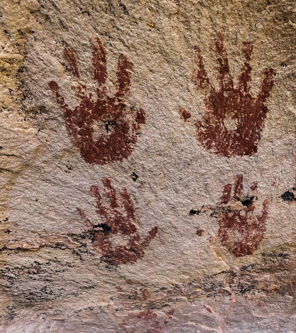 hands on cave walls